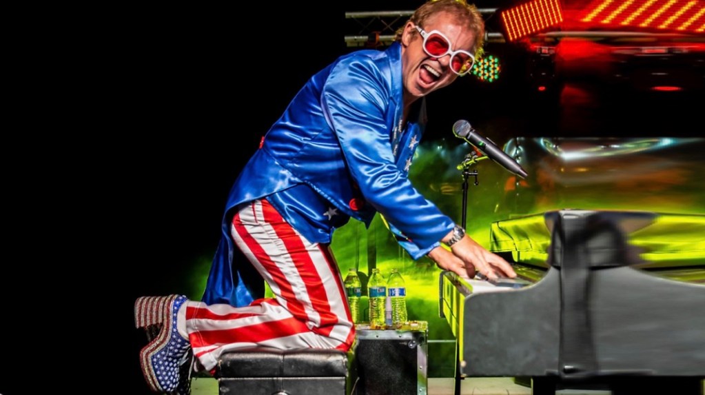 Kenny Metcalf as Elton Flag Suit